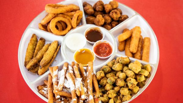 An assortment of 8 Wings & Burger Combo on a platter with dipping sauces.