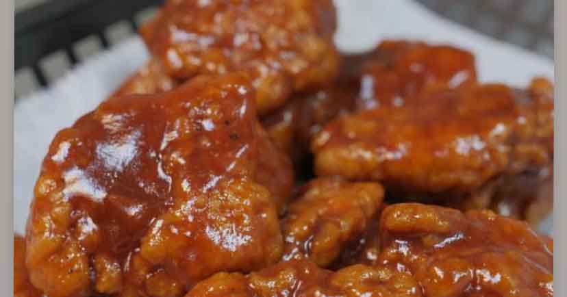 Saucy buffalo wings on a plate.