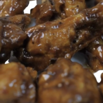 Close-up of glazed chicken wings.