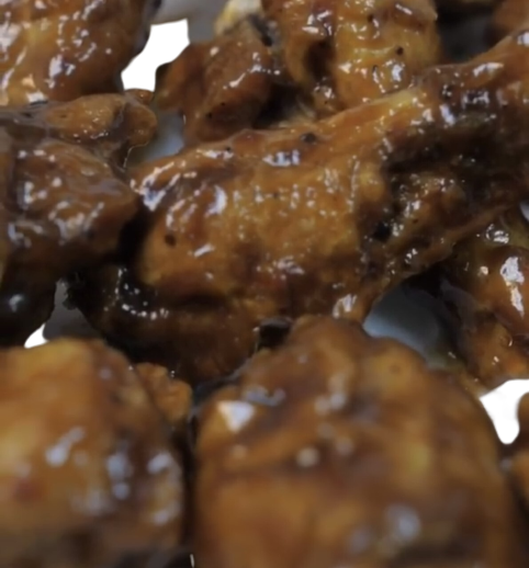 Close-up of glazed chicken wings.