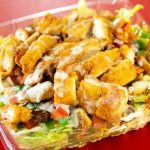 A crispy chicken salad with ranch dressing in a plastic container.