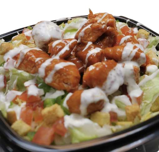 A serving of buffalo chicken salad with ranch dressing in a black takeout container.