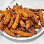 A plate of crispy sweet potato fries.
