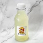 Plastic bottle containing a yellow liquid on a marble surface.